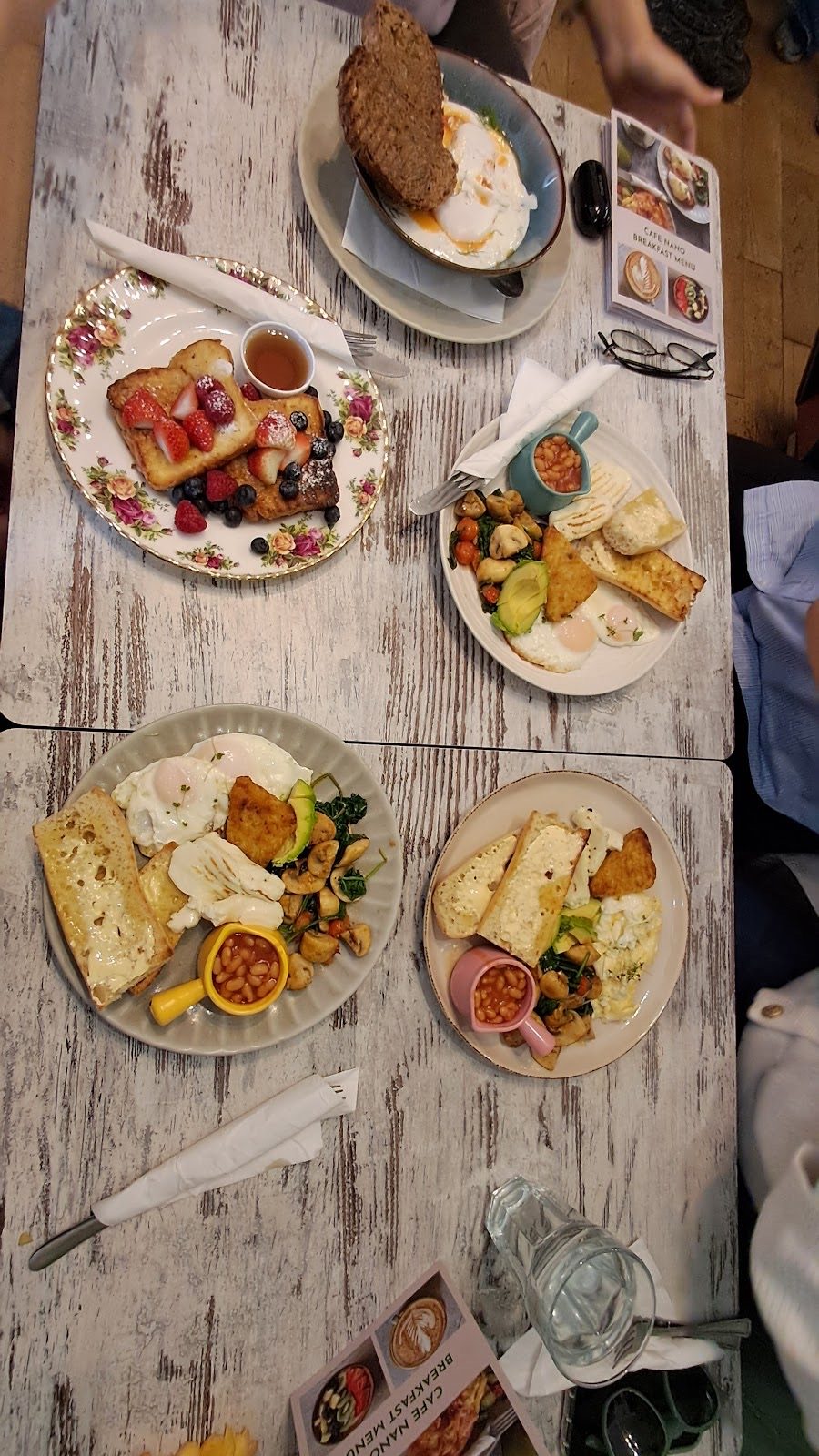 Looking down a long table crowded with sharing plates and drinks