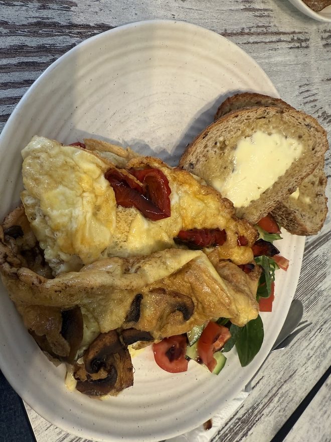 Egg dish with peppers and mushrooms in strong daylight
