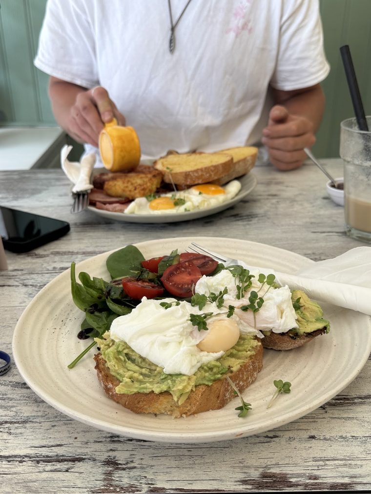 Avocado toast with poached egg and a side salad